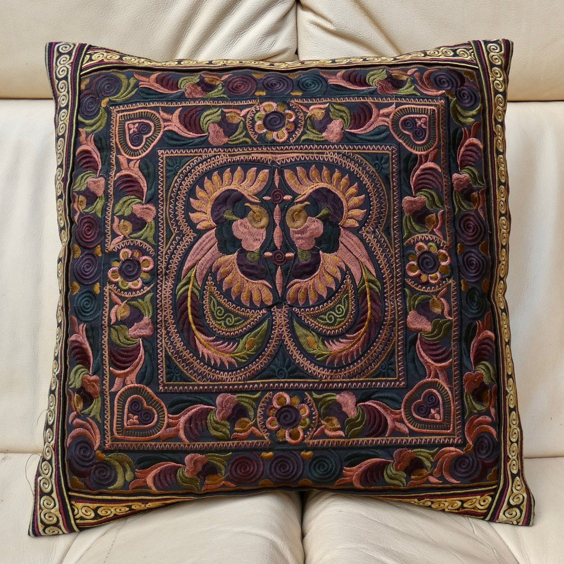A multicolored embroidered cushion cover featuring a traditional Thai design, with no visible cushion inner.