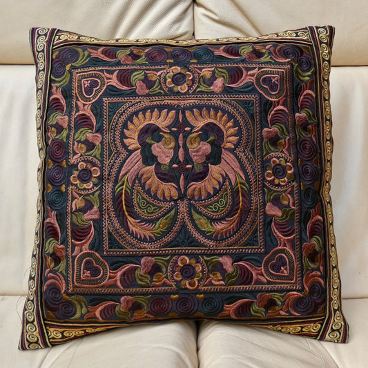 A multicolored embroidered cushion cover featuring a traditional Thai design, with no visible cushion inner.