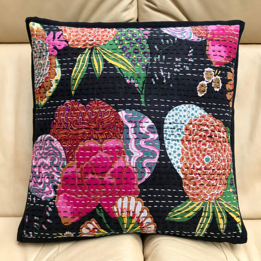 A black cushion cover with a colorful floral hand-stitched Kantha design.